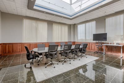 Modern conference room with presentation display at Millennium Plaza