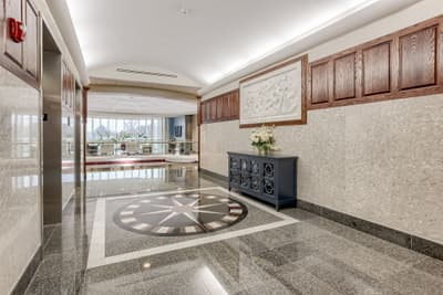 Millennium Plaza lobby entrance with compass rose floor and marble relief artwork