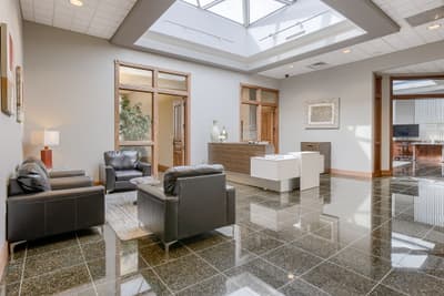 Suite reception area at Millennium Plaza with skylight and leather seating